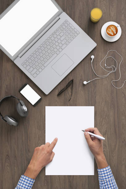 istock Business man writing on a plank paper at an office desk 959295490
