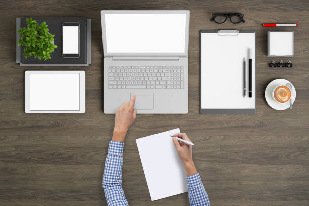 istock Business man writing on a plank paper at an office desk 959295514