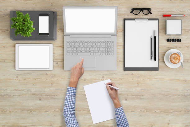 istock Business man writing on a plank paper at an office desk 959295516