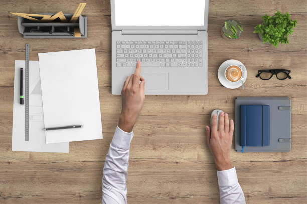istock Man working on a laptop knolling overhead view 959295518