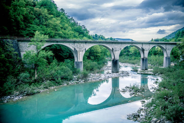 Old steam train on bridge over Soca River in Ajba, Primorska region, Slovenia, Europe. Nikon D850.
