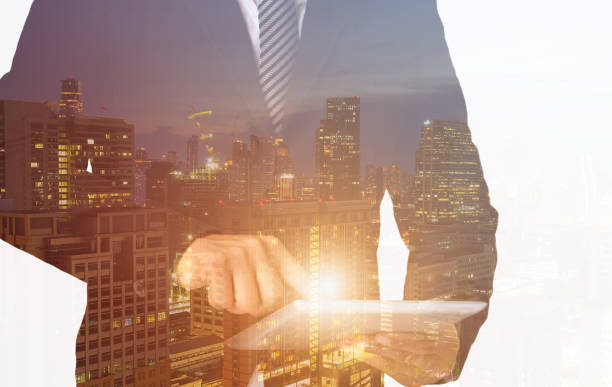 istock Double exposure smart hands touch screen tablet young businessman 959296280