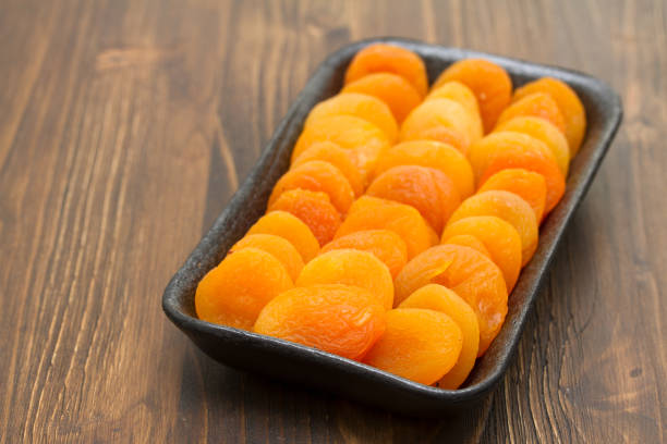 istock dry apricot on black plastic dish 959304044