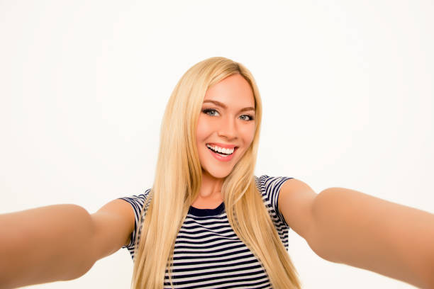 istock Attractive smiling young woman making pretty selfie 959304420