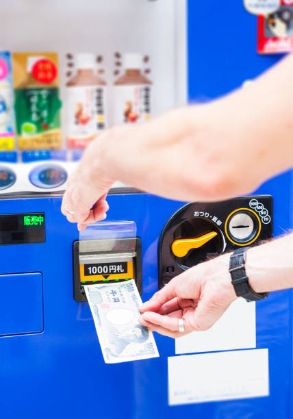 istock Hand Inserting Money into Vending Machine in Tokyo, Japan 959304834
