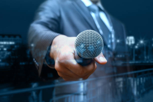 istock Businessman holds out the microphone. 959307716