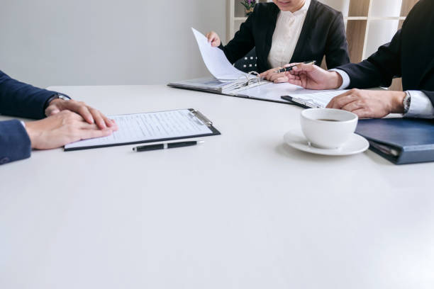 istock Interviewer or Board reading a resume during a job interview, Employer interviewing a young male job seeker for recruitment talking in modern office, employment and recruitment concept 959307930