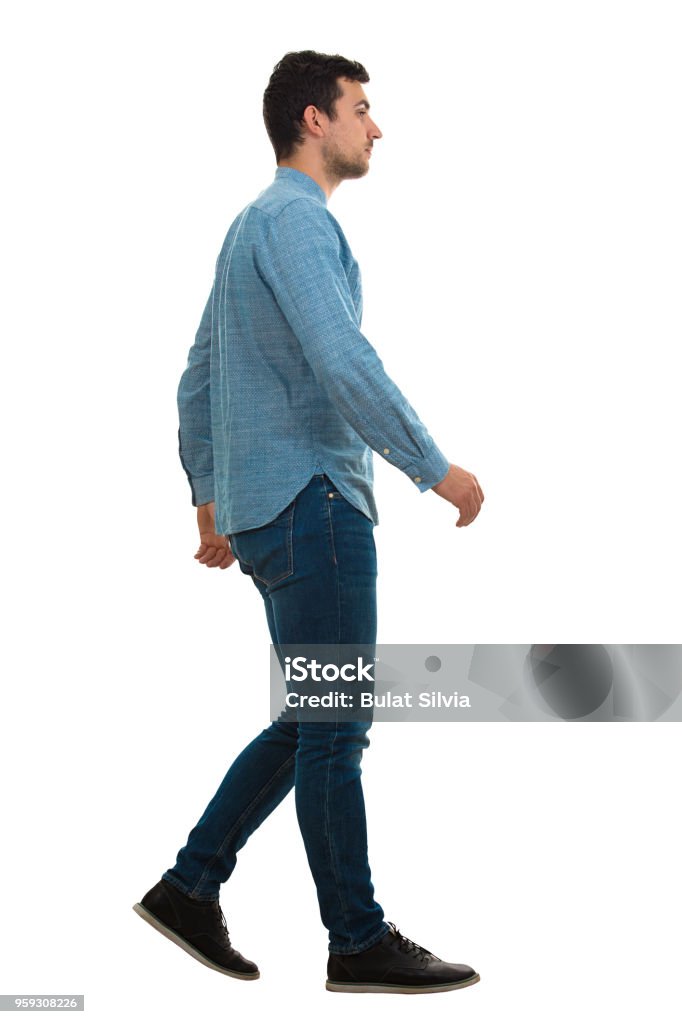 man walking isolated on white background Full length profile shot of a young confident man walking isolated on white background Men Stock Photo