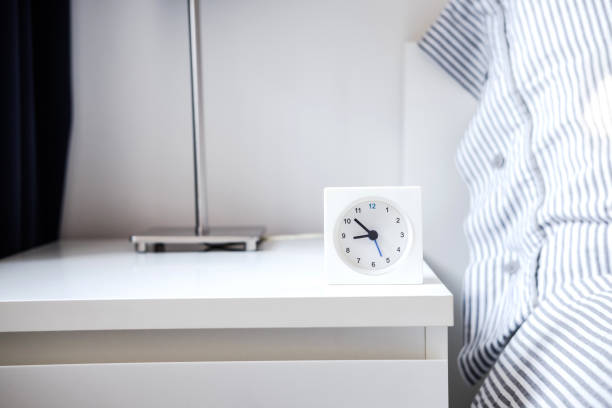istock Alarm clock in white bedroom iterior 959308766