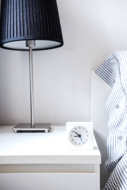 istock Alarm clock in white bedroom iterior 959308812