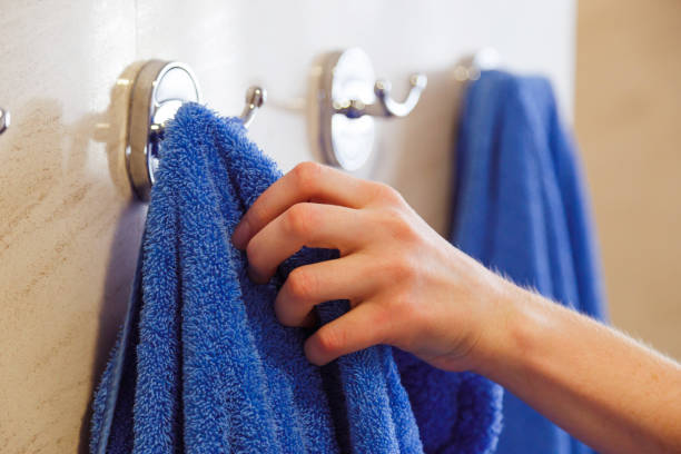 towel for hands hanging on a rack in the bathroom stock photo