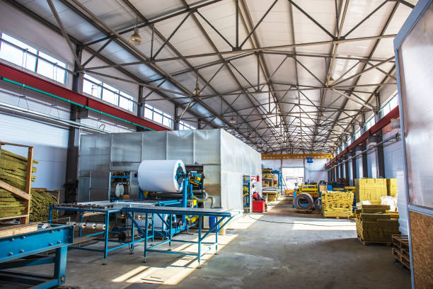 istock Thermal insulation production line. Machine tools for production of sandwich panels, roller conveyor in workshop, industrial interior, large hangar 959308920
