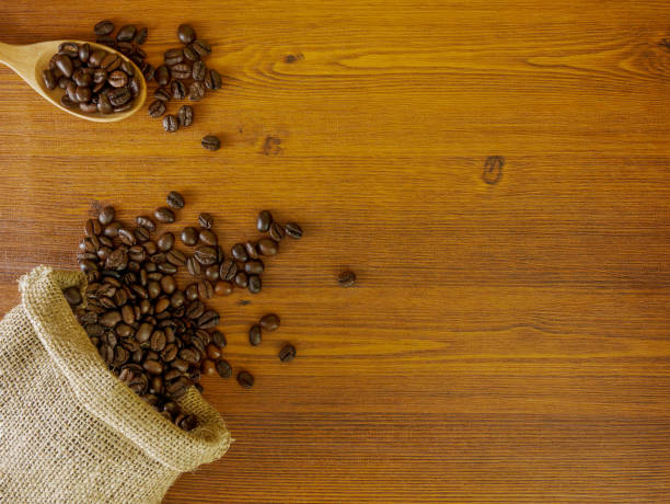 istock Flat lay coffee beans on wooden table 959312648