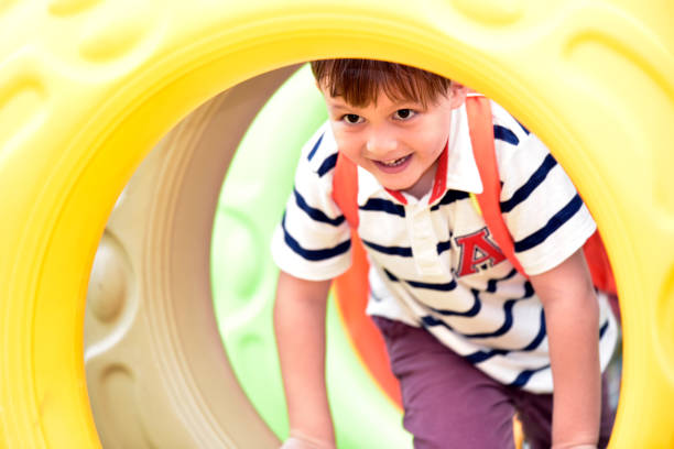 istock Kindergarten boy in the playground . 959313020