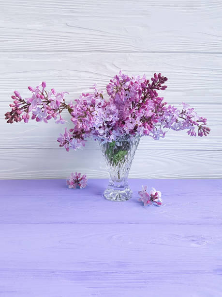istock vase with lilac on a wooden background 959323082