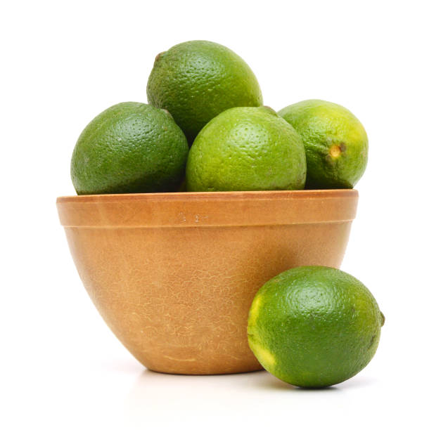 istock A green lemons on wooden bowl 959323376