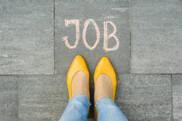 istock Female feet with text job written on grey sidewalk 959324898
