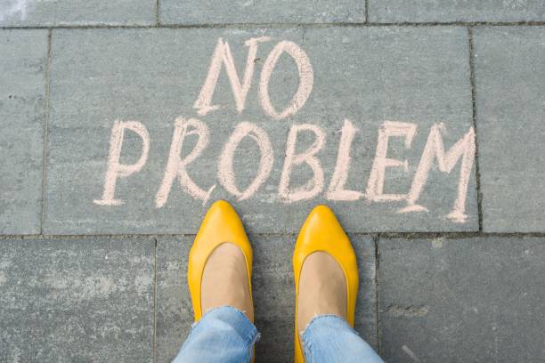 istock Female feet with text no problem written on grey sidewalk 959328142