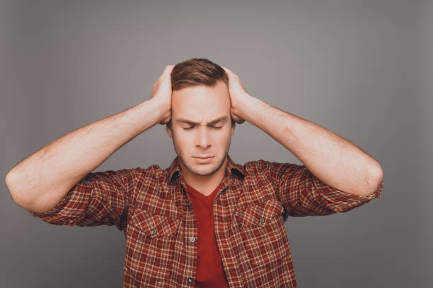 istock Portrait of young businessman touching head and having big problems 959331182