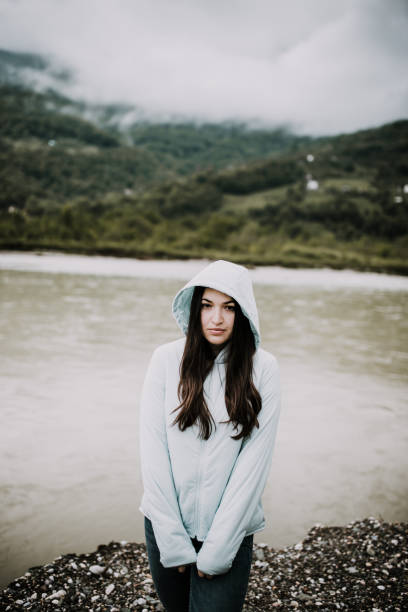 istock Beautiful girl standing next to a mountain river 959331628