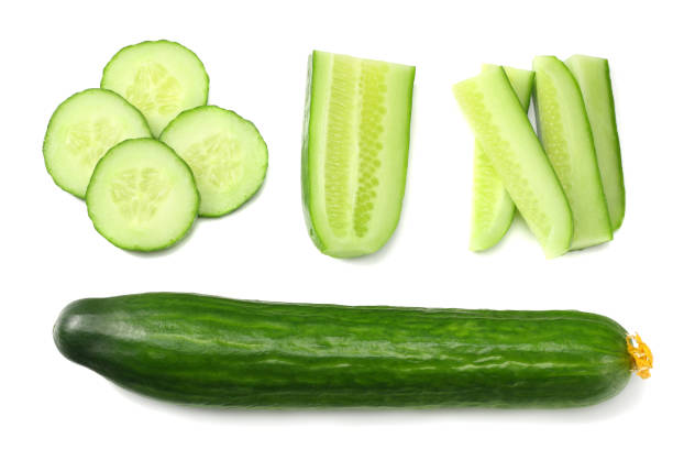 istock fresh cucumber slices isolated on white background. top view 959332616