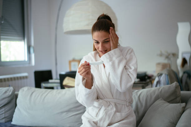 istock Young woman holding a home pregnancy test 959336824