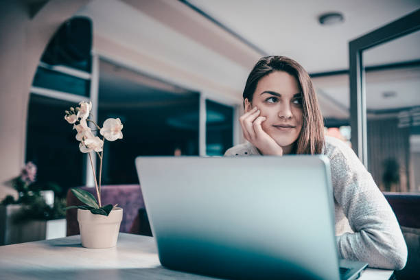 istock Young Cheerful Female Working on Computer at Home 959339424