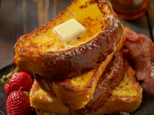 Brioche French Toast with Bacon and Eggs Brioche French Toast with Bacon, Eggs and Fresh Fruit french toast bacon bread butter stock pictures, royalty-free photos & images