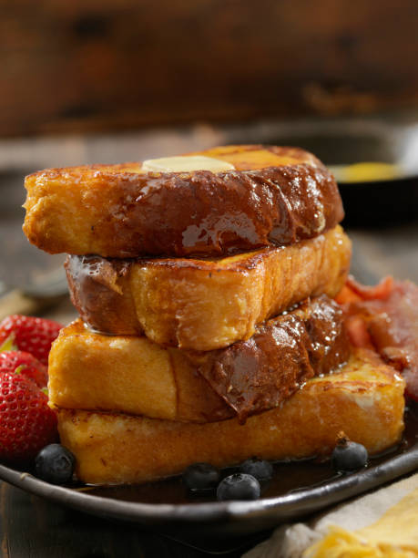 Brioche French Toast with Bacon and Eggs Brioche French Toast with Bacon, Eggs and Fresh Fruit french toast bacon bread butter stock pictures, royalty-free photos & images