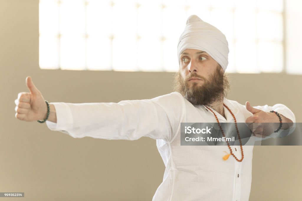 Kundalini. Man practicing yoga. Warrior II pose Kundalini Stock Photo