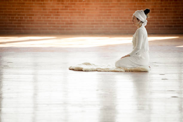 Kundalini. Woman practicing yoga. Sun salutation