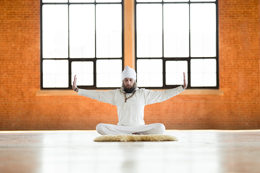 Kundalini. Man practicing yoga. Meditating in lotus pose