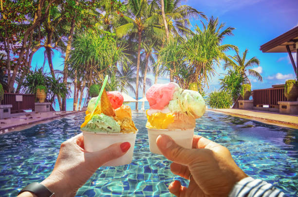 Couple with beautiful bright  sweet Italian ice-cream with different flavors  in the hands stock photo