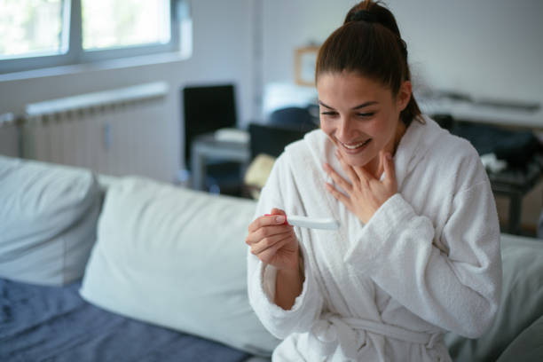 istock Woman looking at home pregnancy test 959359822