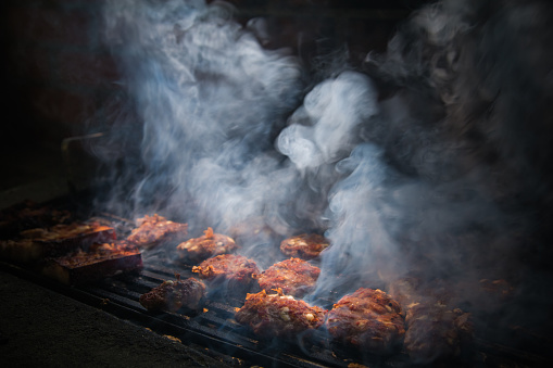 Juicy spicy beef burger grilled on smoky grill