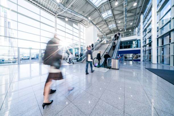 istock blurred people walking in a modern hall 959364642