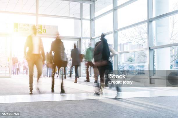 Blurred People Walking In A Modern Hall Stock Photo - Download Image Now - Tradeshow, Visit, Exhibition