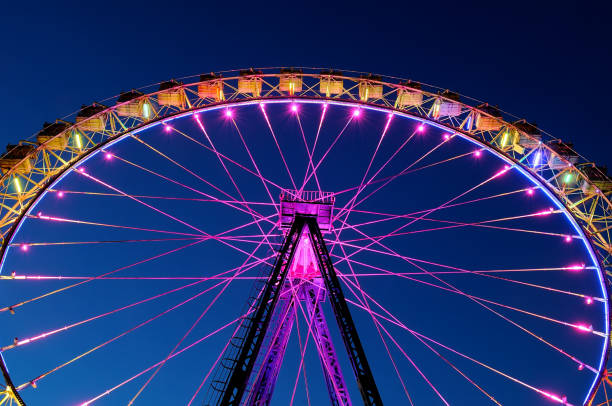 istock Big ferris wheel with festive colorful illumination 959366826