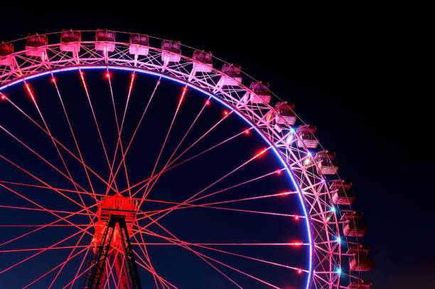 istock Big ferris wheel with festive red and purple illumination 959366902