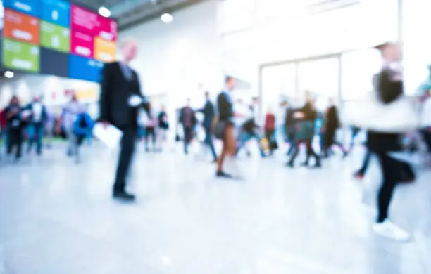 blurred business people walking in a modern hall