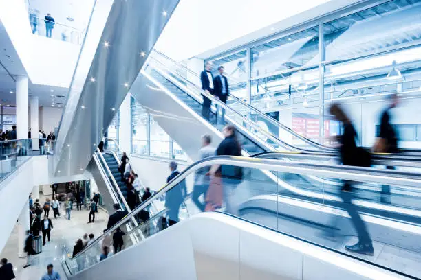 blurred business people walking in a modern hall