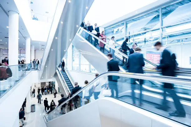 blurred business people walking in a modern hall