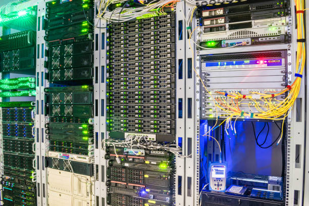 istock Racks with servers are installed in the server room of the data center. Multiple optical wires connect to the central router. The technical node of the Internet provider 959367748