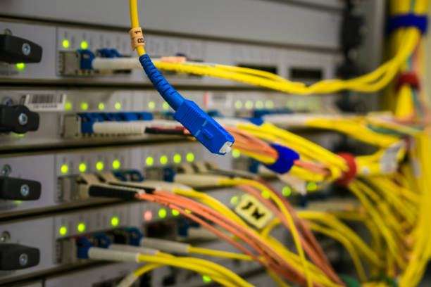 istock Fiber optic Patch-Cord is on the background of the central router in the data center server room 959367828