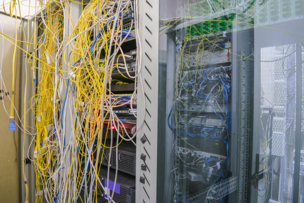 istock Racks with servers are located in the server room.Messy internet wires have a connection to computer servers. Cabinets with computer equipment are located in the data center 959367880