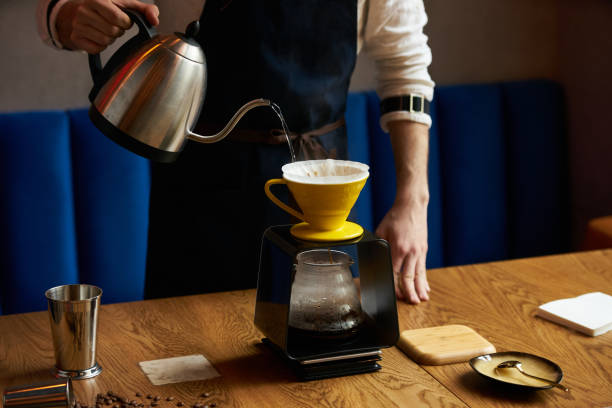 istock Barista pouring water on coffee ground with paper filter 959371834