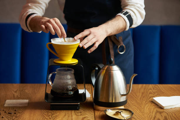 istock Barista pouring water on coffee ground with paper filter 959372416