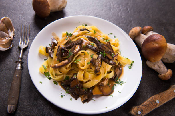 Pasta with mushrooms Tagiatelle pasta with creamy sauce with porcini mushrooms porcini mushroom stock pictures, royalty-free photos & images