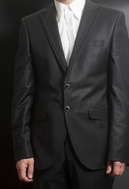 istock Man in black suit and white shirt 959377234
