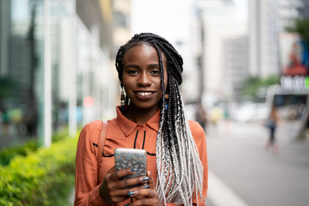 istock Afro Woman Using Mobile at Street 959382626